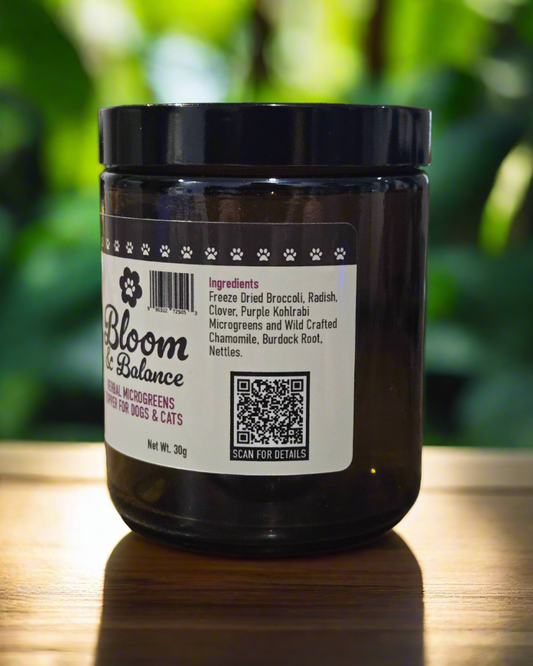 Glass jar with text showing the ingredients: Freeze dried broccoli, radish, clover and purple kohlrabi microgreens as well as wild crafted chamomile, burdock root and nettles.
There is also a QR code to scan that bring you to the product page on www.jennuinepetservices.ca